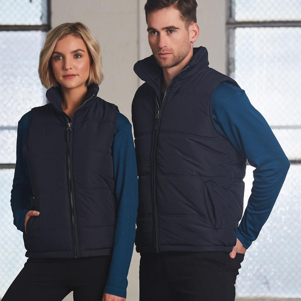 Navy puffer vest with front zip and lower pockets, shown over teal long sleeve top