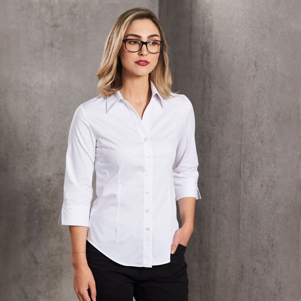 Woman wearing white fine twill tailored fit shirt with 3/4 sleeves, point collar, and button placket
