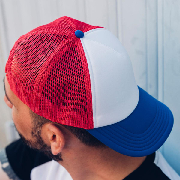 Man wearing red mesh trucker cap with white front panel, royal blue flat brim and blue snap button