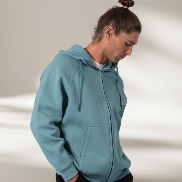 Slate blue zip-up hoodie with kangaroo pocket and drawstring hood on male model
