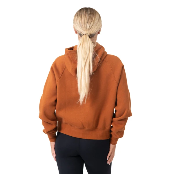 Back view of burnt orange half-zip hoodie with hood up, ribbed cuffs and hem visible on blonde model