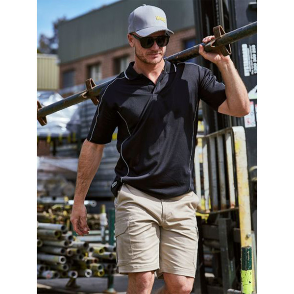 Man on worksite wearing black cool mesh polo with white contrast reflective piping on shoulders and sides