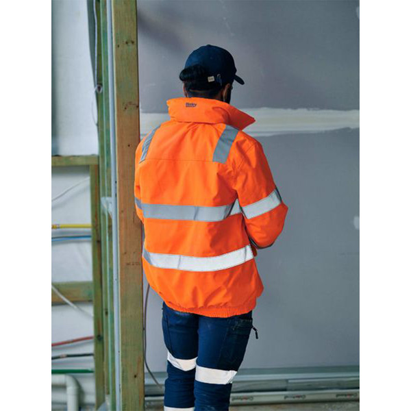Fluorescent orange hi-vis bomber jacket with silver reflective tape on torso and sleeves, rear view