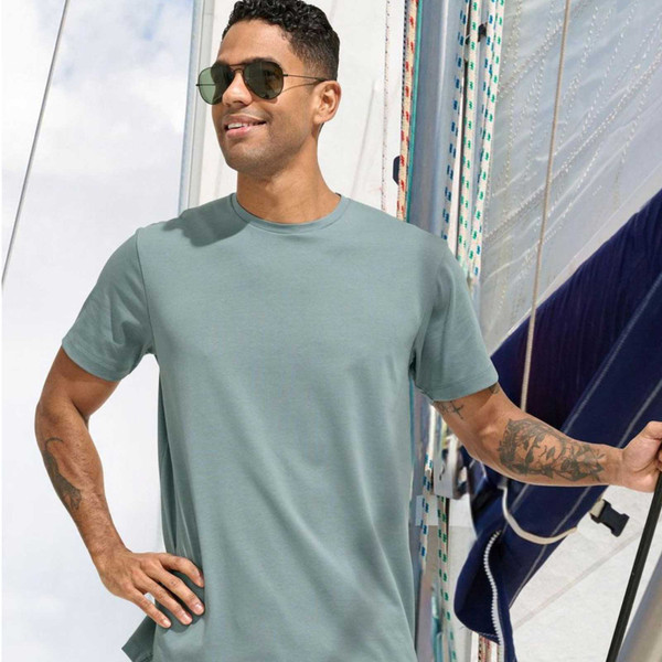 Sage green crew neck t-shirt with smooth cotton face and short sleeves on male model