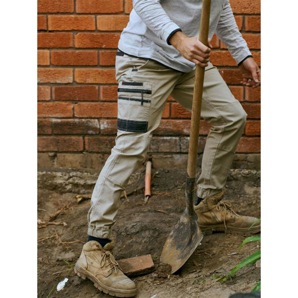Stone cargo pants with charcoal knee panel detail and elasticated cuffs, worn with work boots