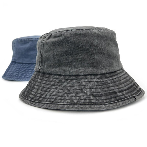 Washed charcoal cotton twill bucket hat with wide brim, pigment-dyed texture, denim blue colourway shown behind