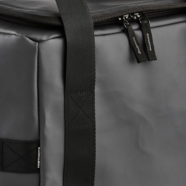 Charcoal grey cooler bag with black webbing straps and dual zipper pulls on top compartment