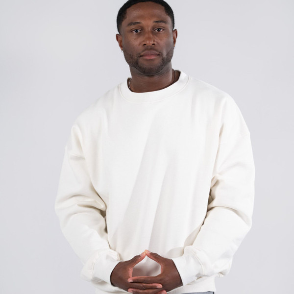 Cream oversized crew neck sweater with dropped shoulders and relaxed fit on model