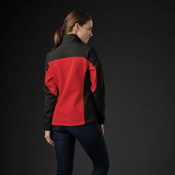 Woman wearing red and black two-tone softshell jacket, rear view showing contrast panel construction