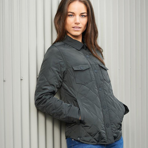 Woman wearing charcoal quilted shirt-style jacket with diamond pattern, button front, chest pockets and snap tabs