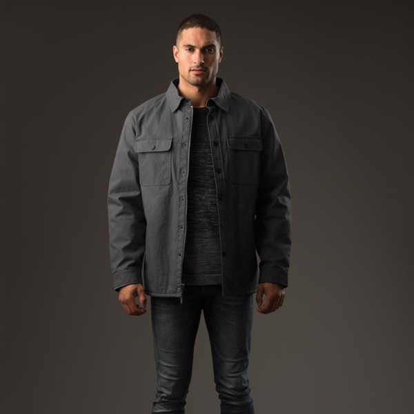 Man wearing charcoal snap-button shirt jacket with dual chest pockets and water-repellent finish over dark marle tee