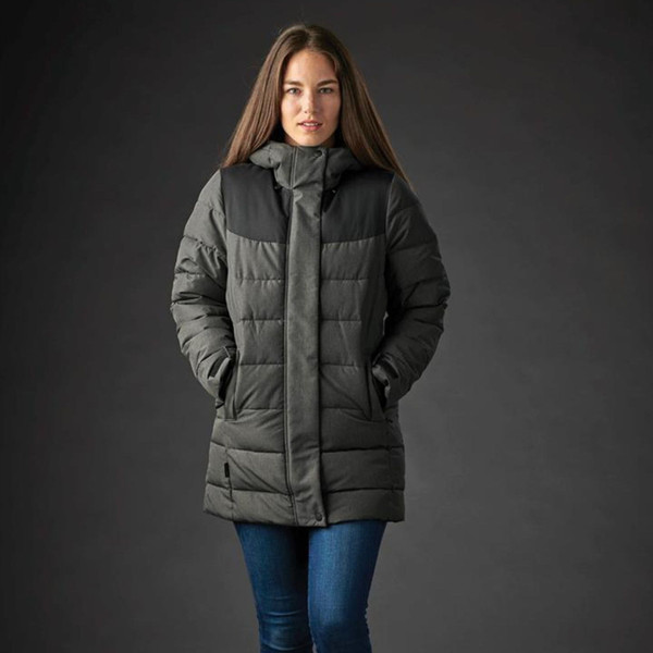 Woman wearing charcoal and black quilted insulated parka with attached hood and zip front, mid-length cut