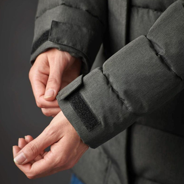 Close-up of charcoal insulated parka sleeve showing velcro cuff adjuster and quilted panelling detail