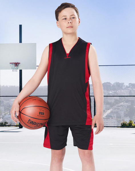 Kids wearing black basketball singlet and shorts with red side panels, holding basketball on outdoor court