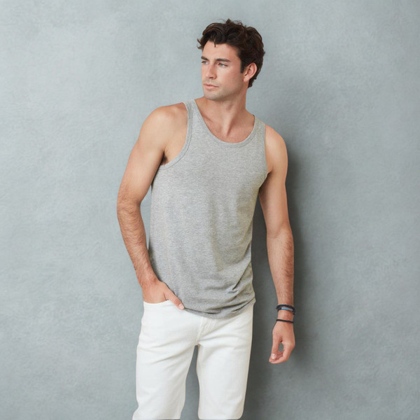 Male model wearing a heather grey body-fit tank top with round neckline and wide armhole, paired with white jeans