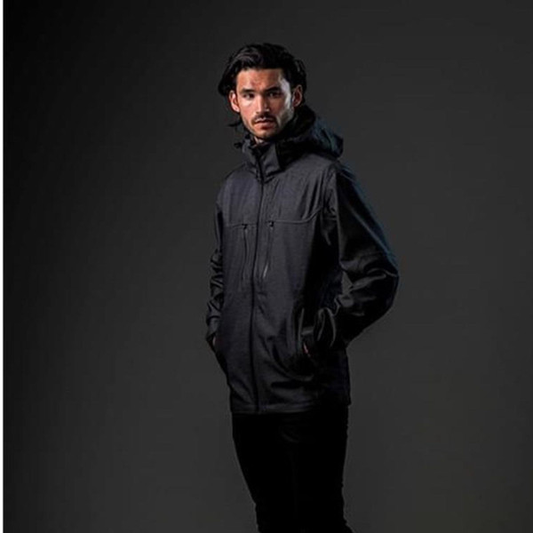Man wearing charcoal heathered softshell jacket with attached hood, centre zip, chest pocket and side hand pockets