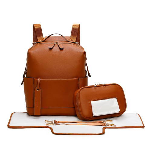 Tan brown faux leather backpack nappy bag set with changing mat, zip pouch, and gold-tone hardware