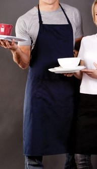 Navy full bib apron with adjustable neck strap worn over grey t-shirt, showing mid-length coverage and wide front panel