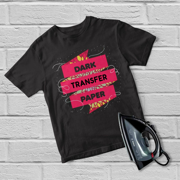 Black t-shirt with hot pink ribbon graphic displaying dark transfer paper text and flame accents