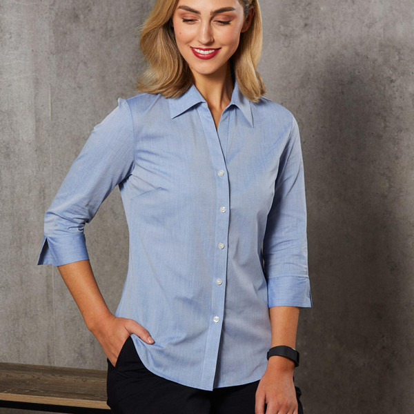 Light blue chambray women's shirt with three-quarter sleeves and classic collar featuring button-front closure