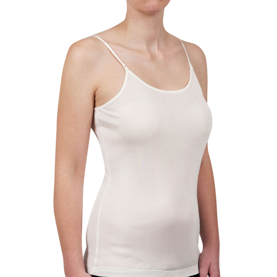 Woman wearing a cream merino wool singlet with thin adjustable straps and scoop neckline, smooth fitted silhouette