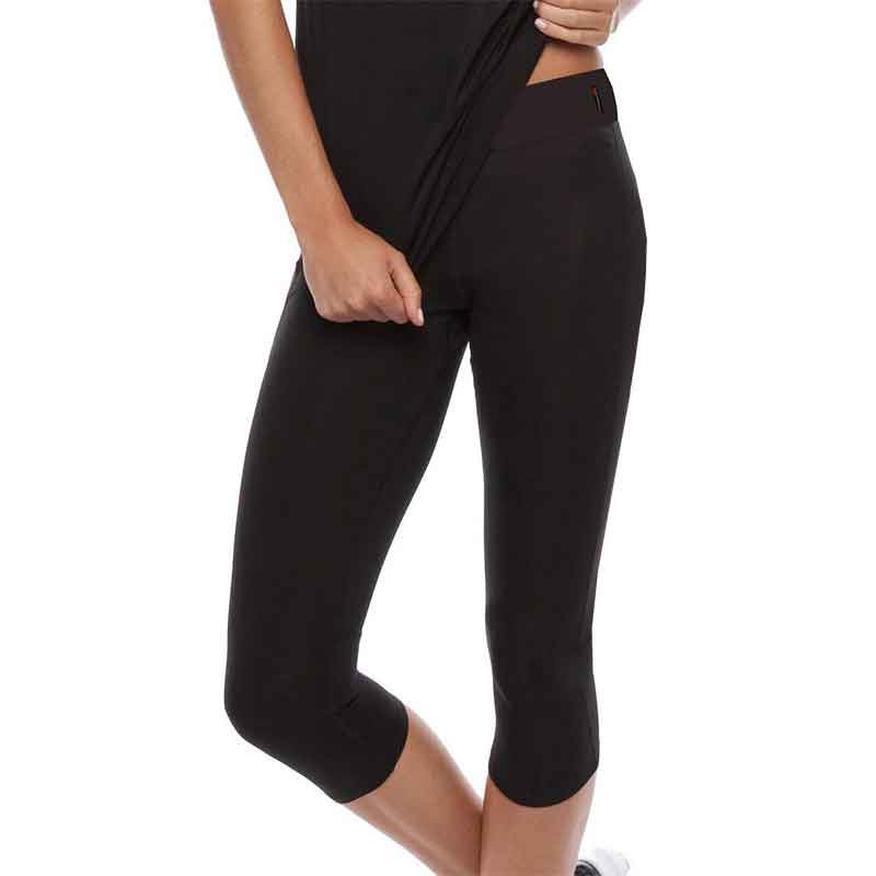 Woman wearing black compression 3/4 leggings with high waistband and slim fitted panels