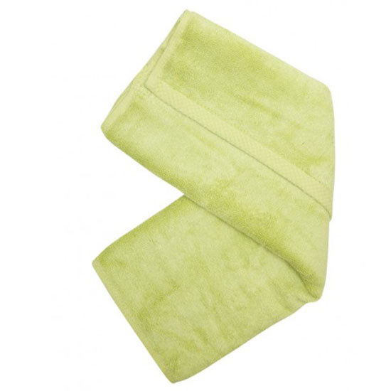 Soft lime green bamboo hand towel displayed in folded ribbon formation showing plush terry texture