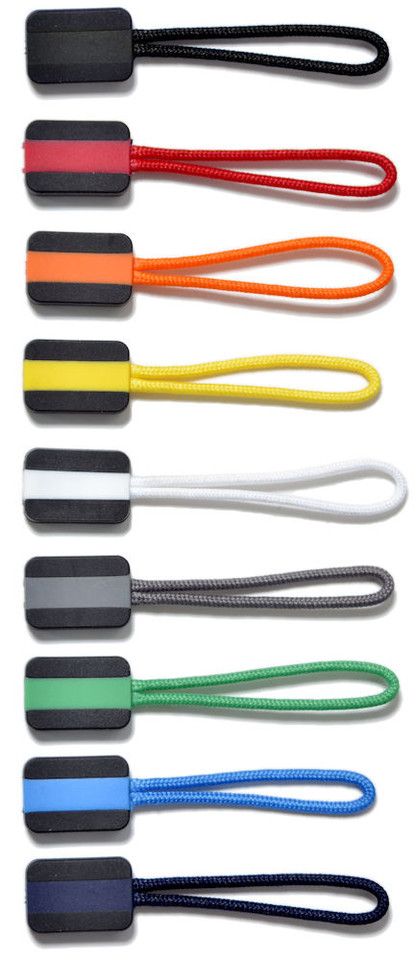 Eight zipper pullers in black, red, orange, yellow, white, grey, green, and blue with matching cord loops on dark rectangular tabs