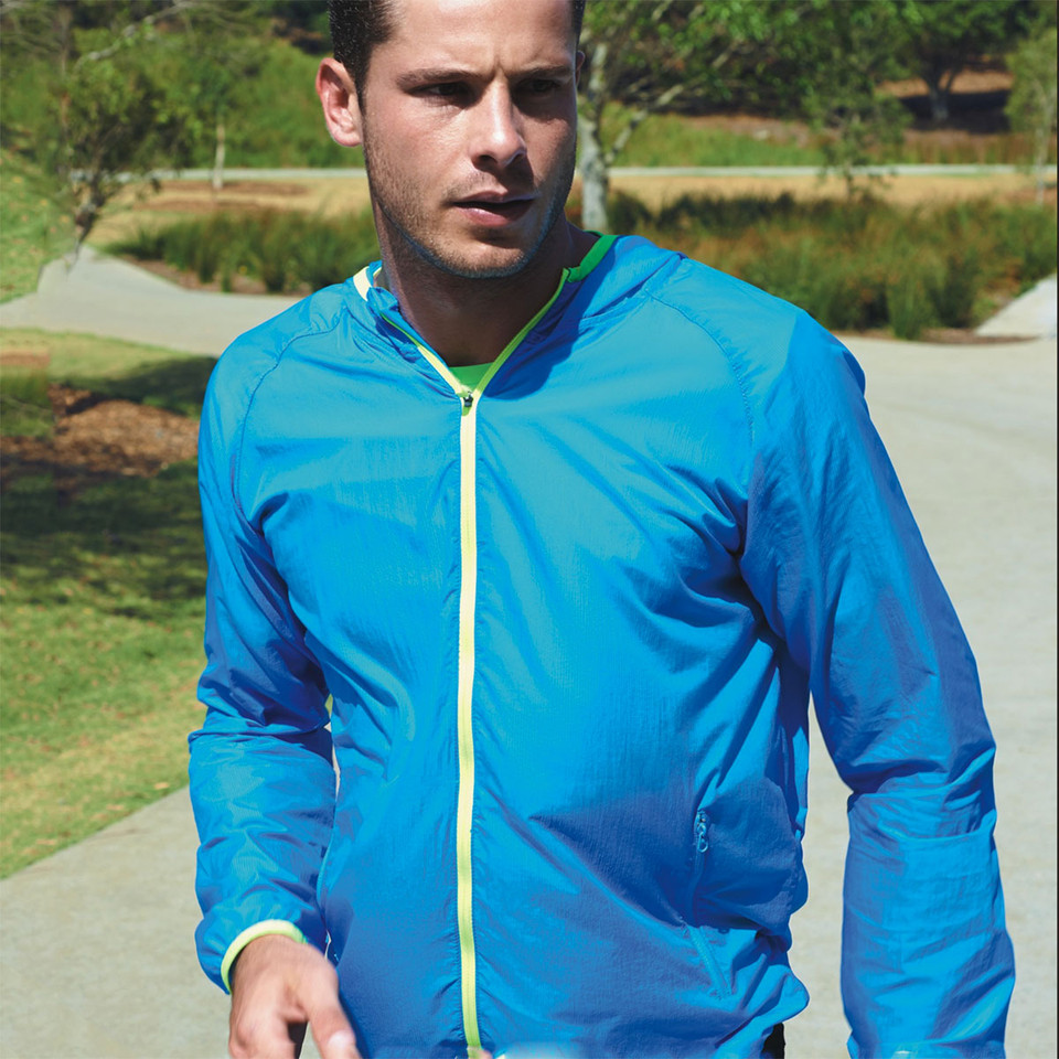 Man running outdoors in electric blue lightweight hooded jacket with lime green contrast zip and cuffs