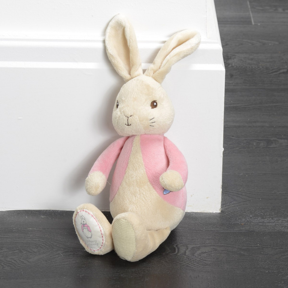 Cream plush bunny toy with pink jacket and embroidered paw details