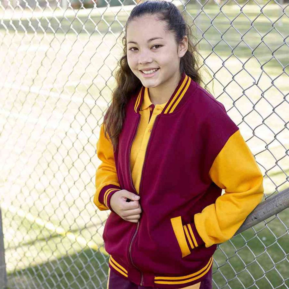 Young girl wearing maroon and gold varsity jacket with contrast sleeves and striped rib trim, zip front, outdoors