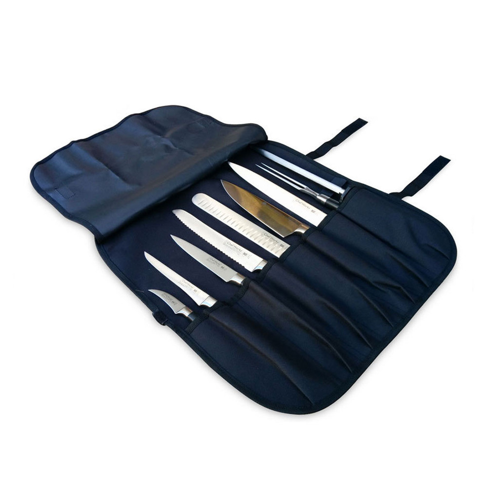 Navy blue roll-up knife wrap with seven pockets holding stainless steel knives and utensils, tie straps visible