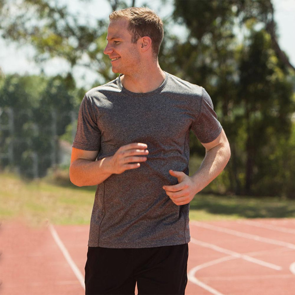 Man running on athletics track wearing charcoal heather crew neck sports tee with short sleeves