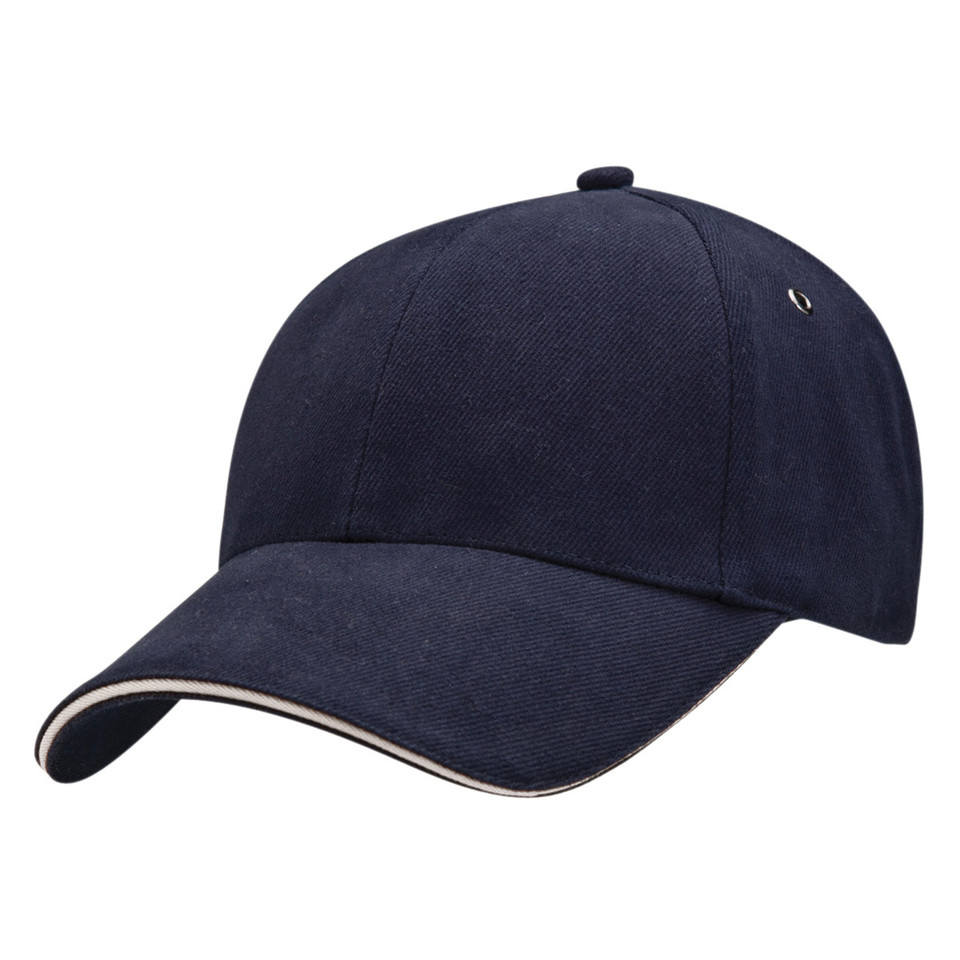 Navy blue six-panel baseball cap with cream sandwich peak brim and metal eyelets, flat lay packshot