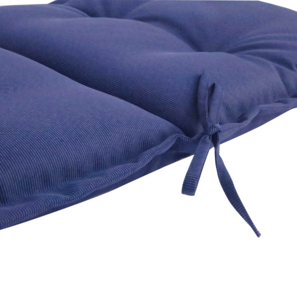 Navy ribbed outdoor cushion with flanged edge and tie fasteners visible at corner