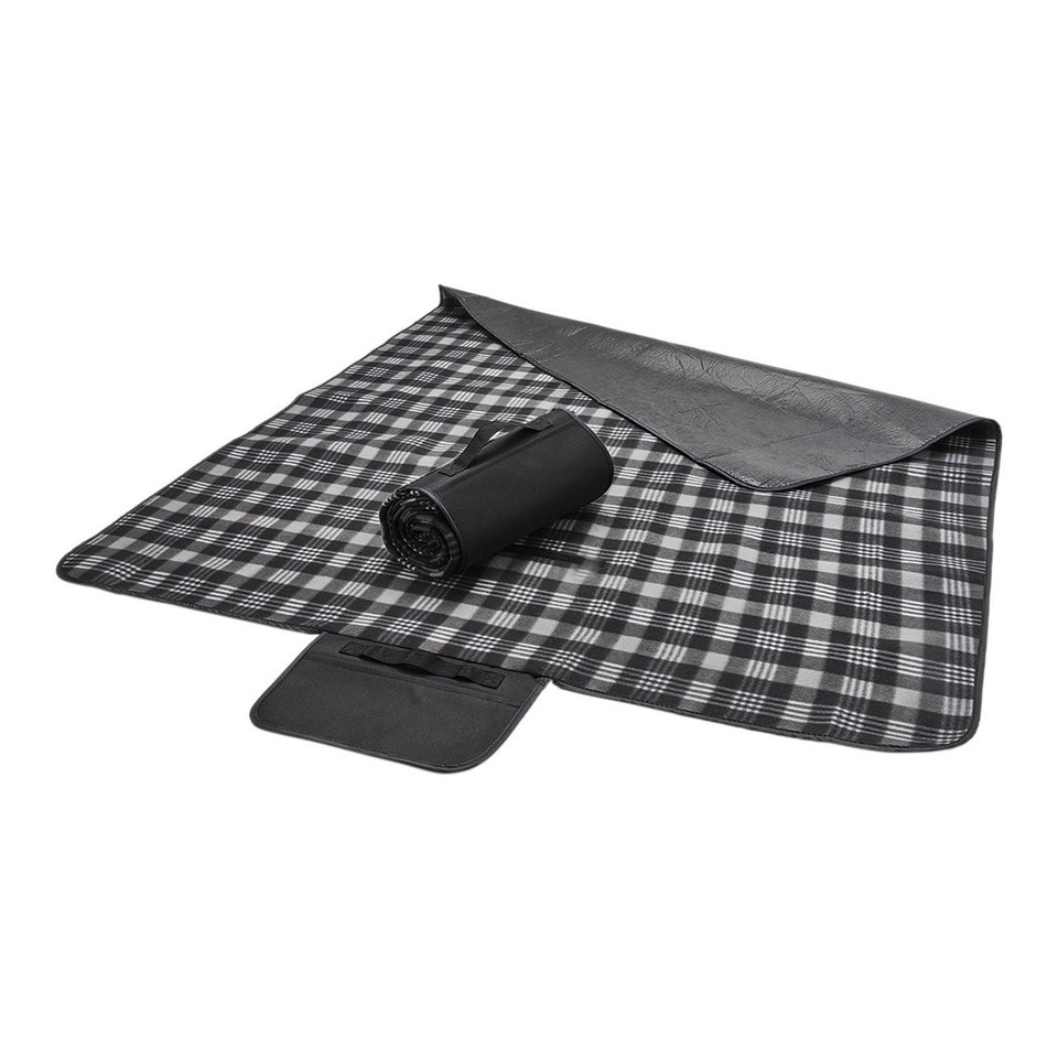 Black and white tartan polar fleece picnic blanket unrolled flat, showing charcoal waterproof backing and rolled storage form