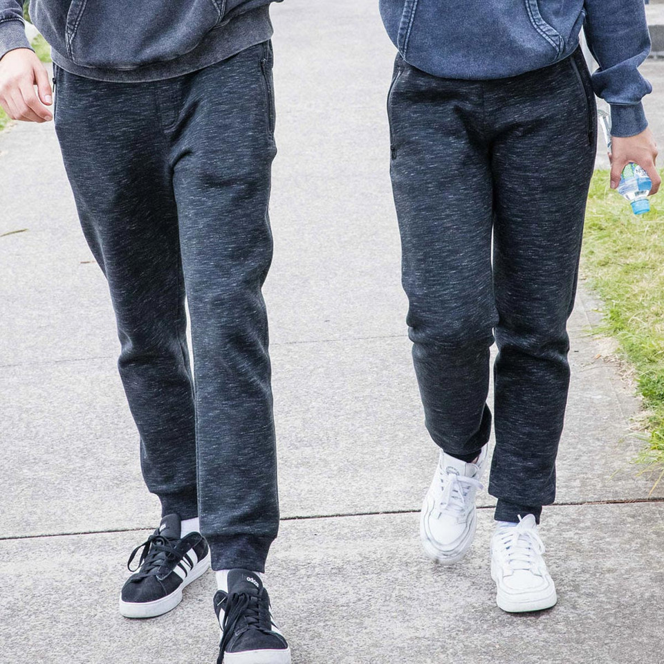 Charcoal marle fleece joggers with cuffed ankles worn by two people outdoors