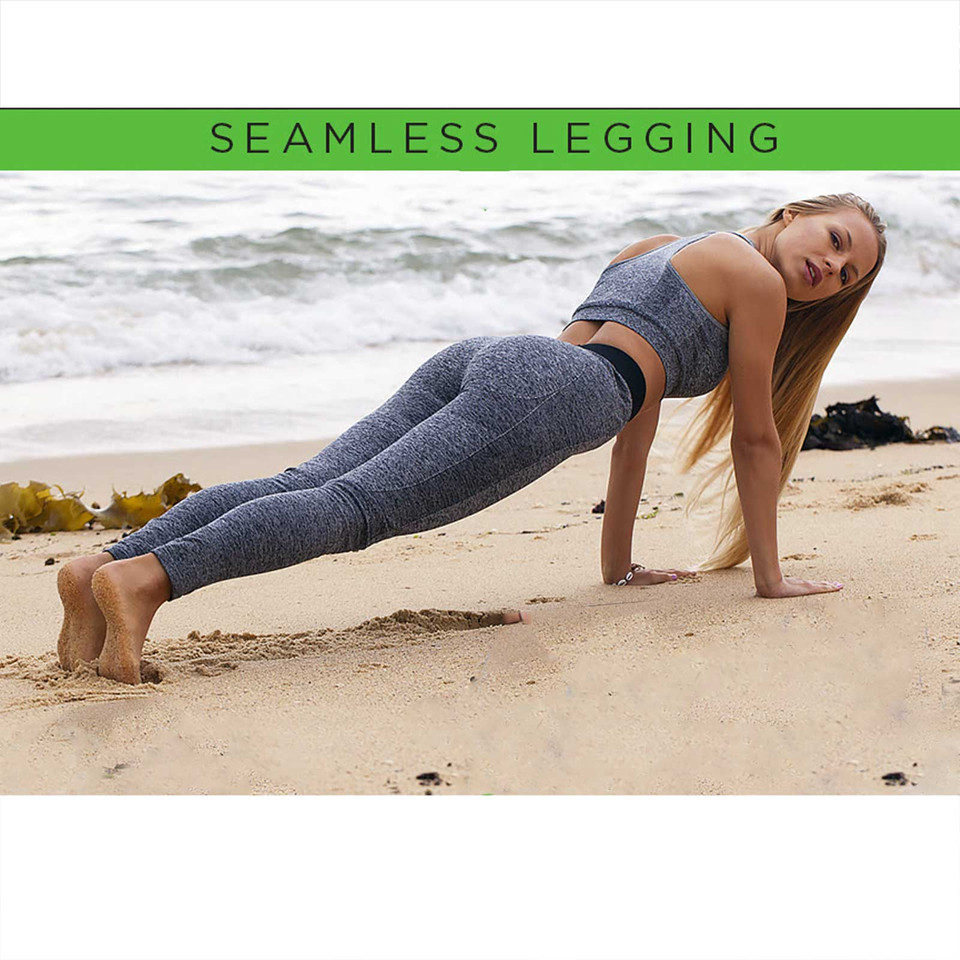 Woman in plank pose on beach wearing grey marl seamless full-length leggings and matching sports bra