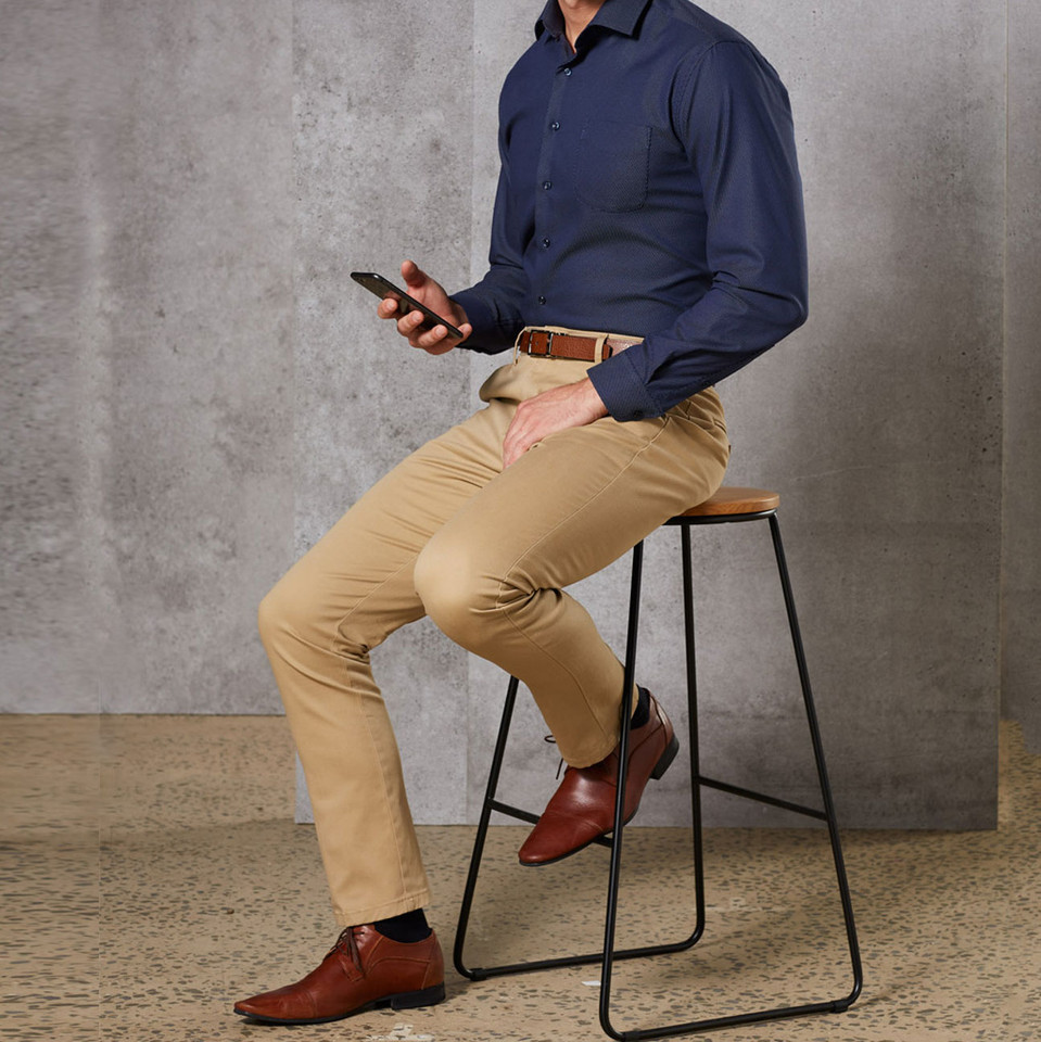 Man wearing navy long sleeve polo shirt with tan slimfit stretch chino pants