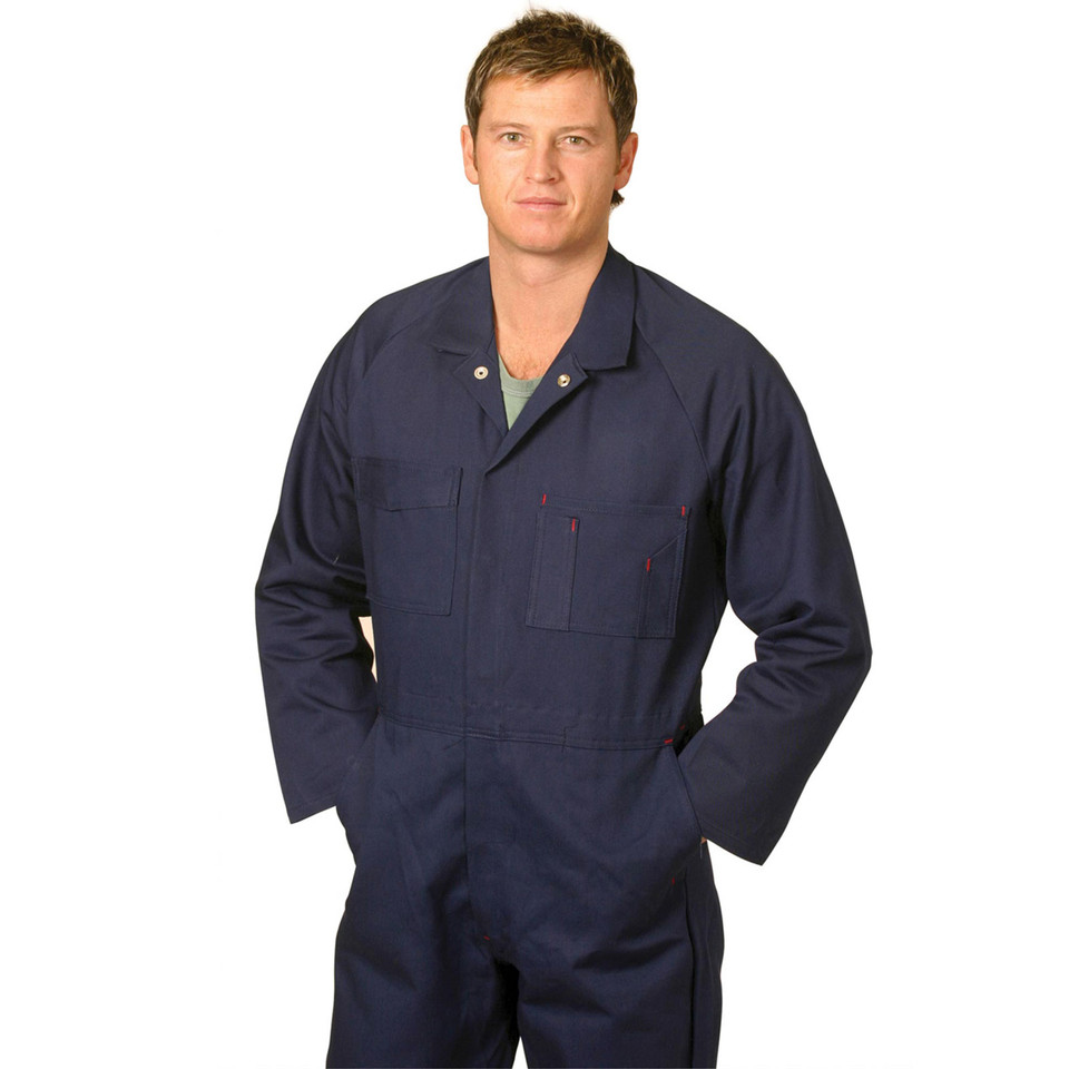 Man wearing navy cotton drill coverall with chest patch pockets and red accent stitching