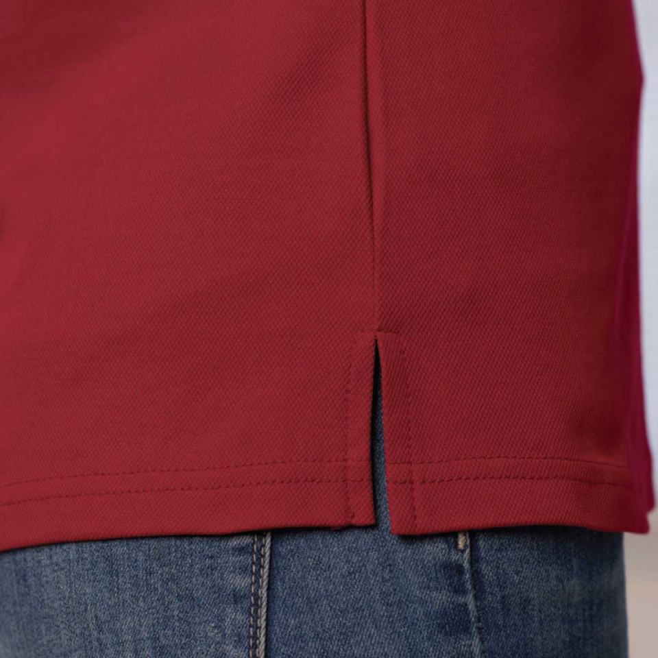 Deep red quick-dry polo shirt showing side split hem detail and ribbed texture fabric