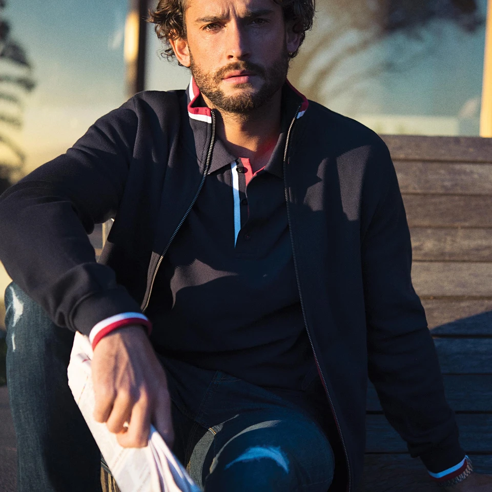 Navy heavy knit zip-up jacket with red, white and blue contrast trim on hood, cuffs and hem