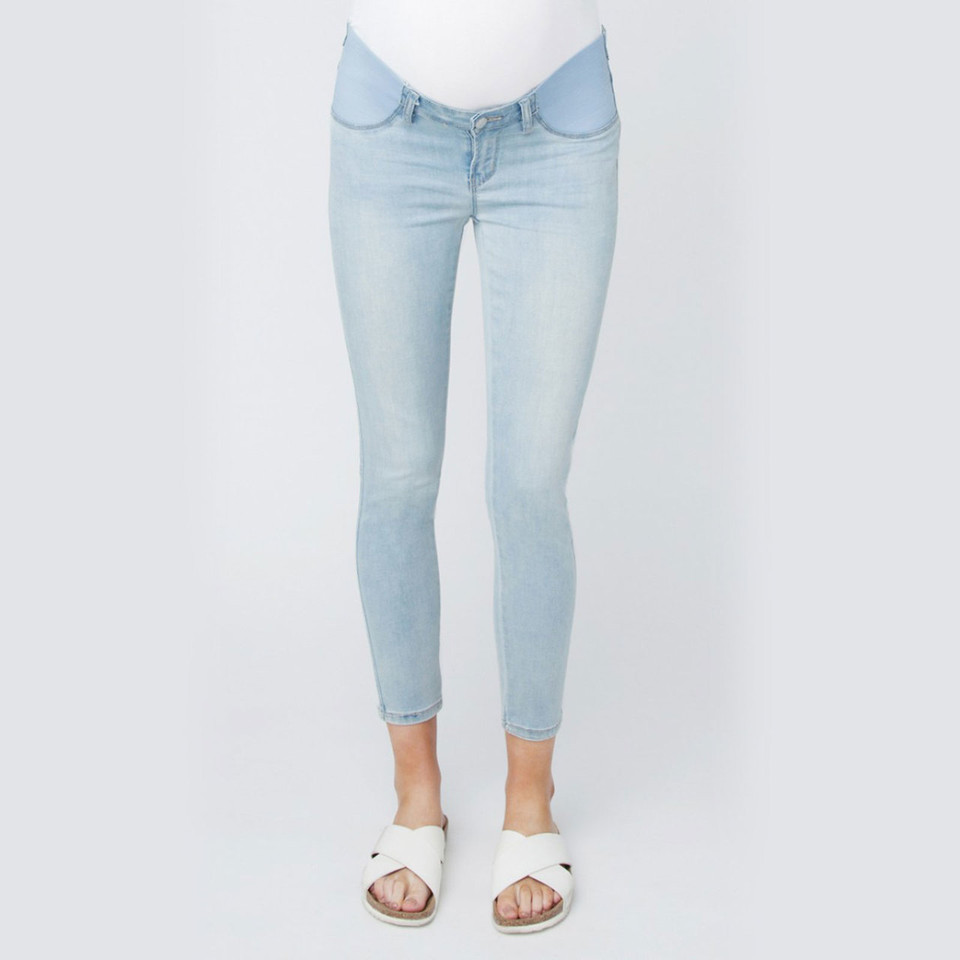 Light wash denim maternity jeggings with over-belly panel and rolled ankle cuffs