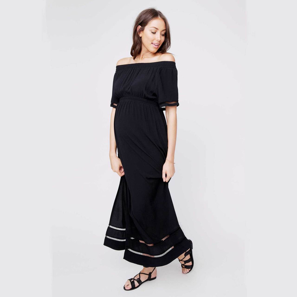 Black off-shoulder maternity maxi dress with elasticated waist and lace trim hem detail, worn by model