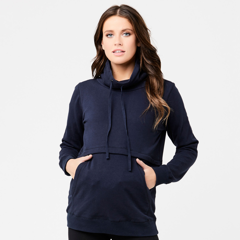 Woman wearing navy funnel-neck fleece jumper with drawstring collar and front kangaroo pocket
