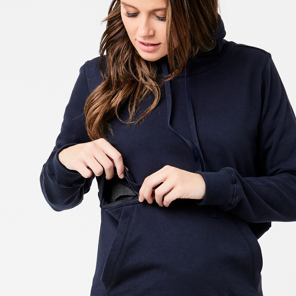Navy maternity hoodie with side-access nursing panel being demonstrated by woman