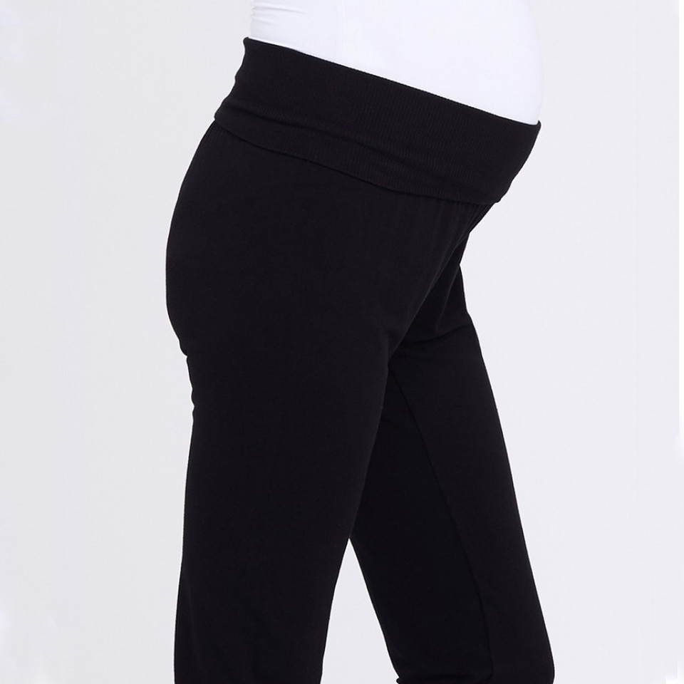 Black maternity lounge pants with wide fold-over waistband, smooth jersey fabric, side profile on model