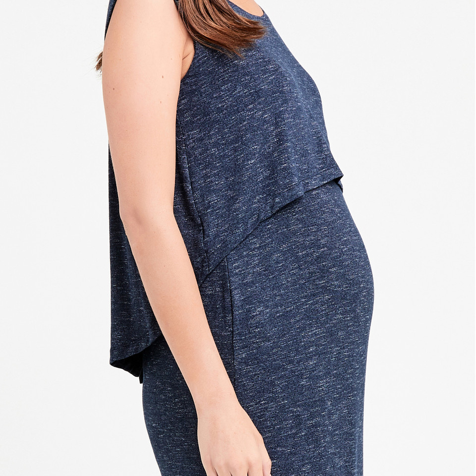 Model wearing a navy marl sleeveless maternity maxi dress with layered swing-back nursing panel