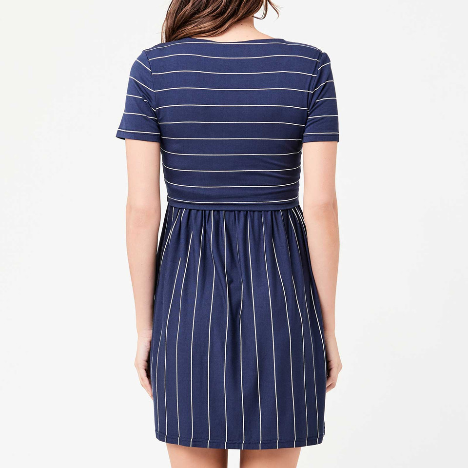 Model wearing indigo stripe nursing dress, short sleeves, contrast horizontal bodice and vertical skirt panels