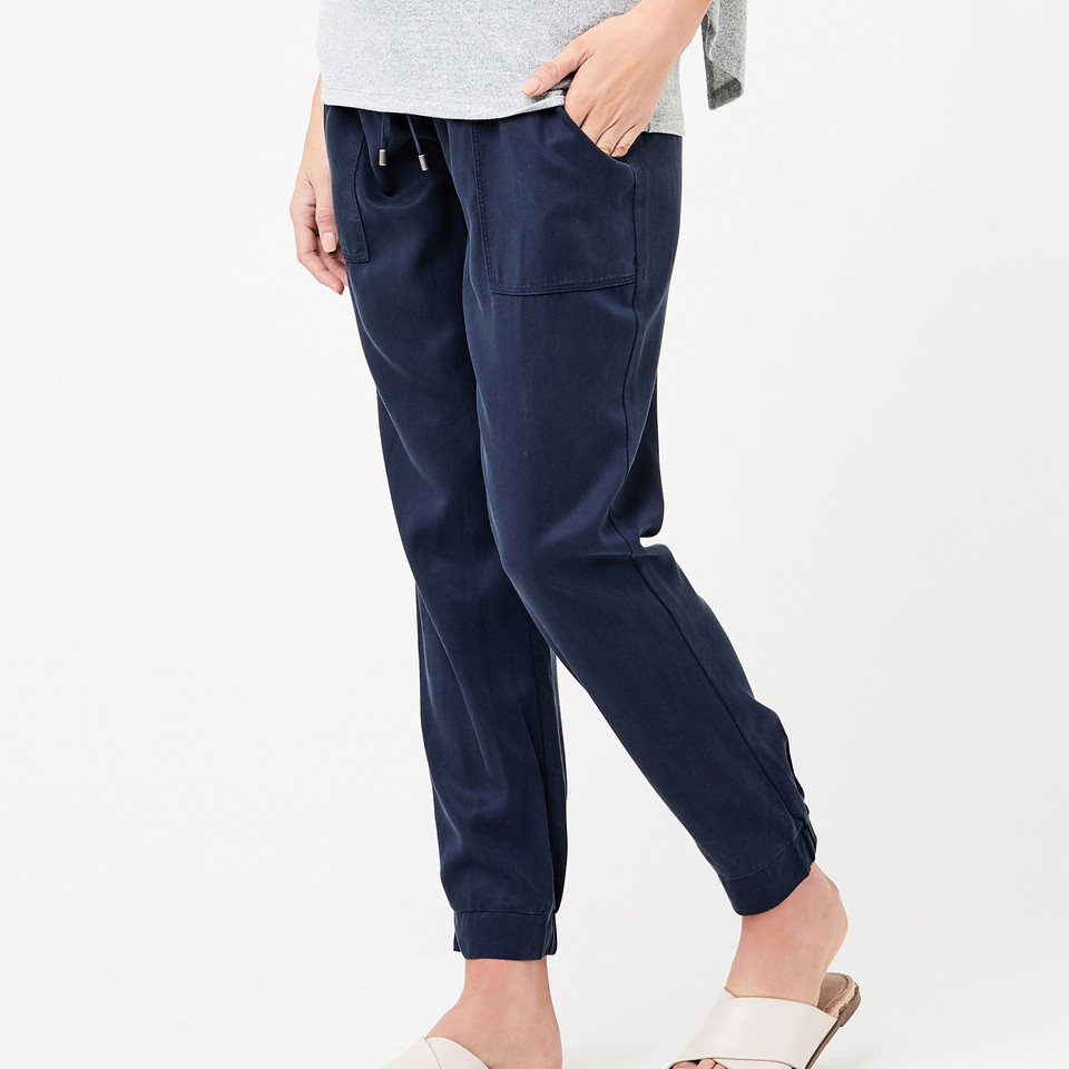 Navy blue maternity jogger pants with elasticated ankle cuffs and side pockets in soft drape fabric